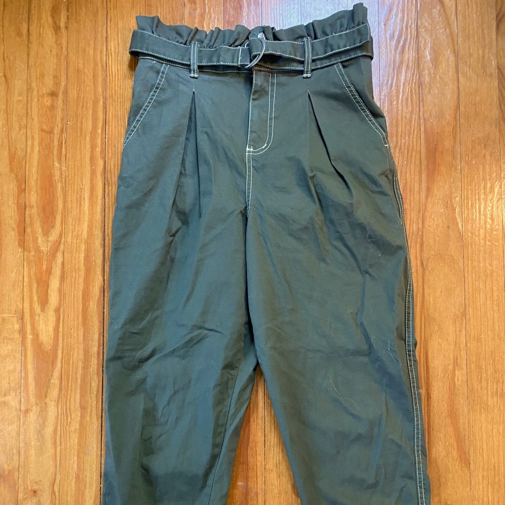 green pants with ruffles and belt